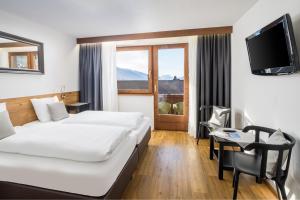 Posteľ alebo postele v izbe v ubytovaní Hotel Standlhof Zillertal