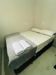 Postel nebo postele na pokoji v ubytování Residencial Yama
