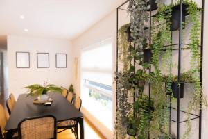 a dining room with a plant wall at Making Memories - Ocean Grove in Ocean Grove