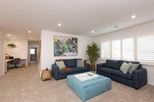 a living room with two blue couches and a table at Making Memories - Ocean Grove in Ocean Grove