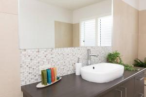 a bathroom with a white sink on a counter at Making Memories - Ocean Grove in Ocean Grove