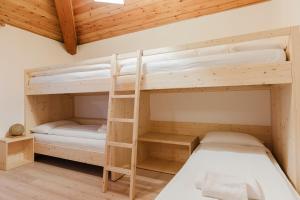 A bed or beds in a room at La Mansarda di nonna Delfa