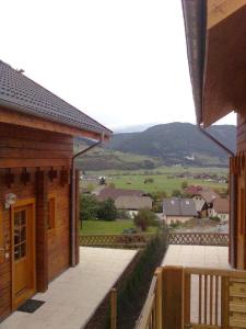 a balcony of a house with a view of a field at Charmantes Ferienhaus in Sankt Margarethen Im Lungau mit Kleinem Garten und Bergblick in Sankt Margarethen im Lungau