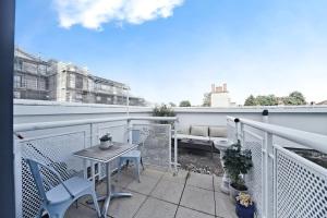 a patio with a table and chairs on a balcony at TTSA - 2 Bedroom Apartment-Croydon - Mayday Hospital in Croydon