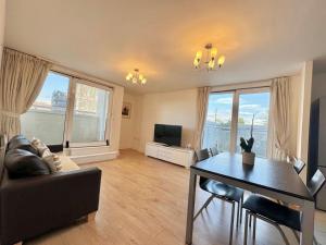 a living room with a couch and a table at TTSA - 2 Bedroom Apartment-Croydon - Mayday Hospital in Croydon