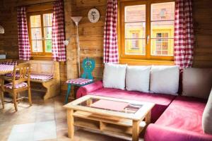 a living room with a couch and a table at Charmantes Ferienhaus in Sankt Margarethen Im Lungau mit Kleinem Garten und Bergblick in Sankt Margarethen im Lungau