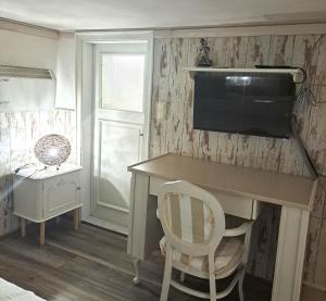 a room with a desk with a television and a chair at Villa Magicland in Sofia