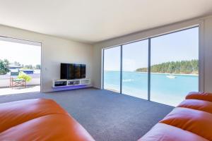 a living room with a view of the ocean at Mapua Wharfside Apartments in Mapua