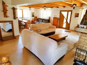 a living room with a couch and a table at Cottage Piatra Craiului in Zărneşti +23 photos