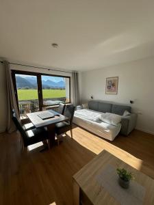a living room with a couch and a table at Haus Sonneneck in Schwangau +25 photos
