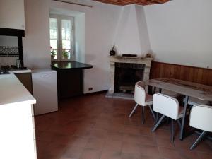 a kitchen with a table and a fireplace at Bed and Breakfast Nicole Ponti in Ponti +35 photos