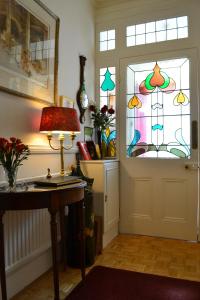 a room with a door with a stained glass window at Knightsrest in Burnham on Sea