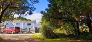 a red van parked in front of a white house at Cottage in Newquay