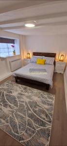 a bedroom with two beds and a rug at Cottage in Newquay