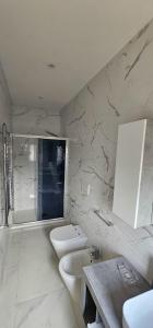a white bathroom with a toilet and a sink at La casa dell'artista in Ardea +69 photos