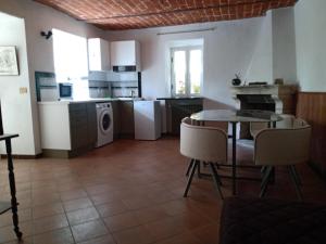 a kitchen and living room with a table and chairs at Bed and Breakfast Nicole Ponti in Ponti