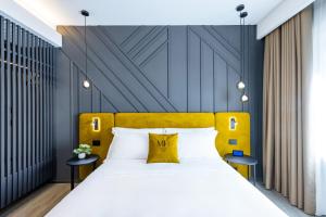 MH SUITES Plebiscito客房内的一张或多张床位