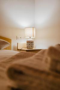 A bed or beds in a room at La Mansarda di nonna Delfa