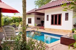 a villa with a swimming pool and a house at Banburi Villa - 2 Bedroom Private Pool Villa in Ao Nang Beach