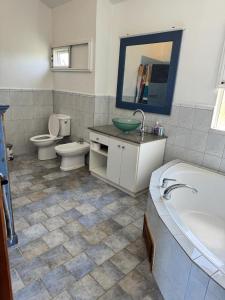 a bathroom with a tub and a toilet and a sink at La Caz in Bouchon +8 photos