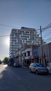 a car parked on the side of a street with a building at Bell Ville Alojamientos in Bell Ville