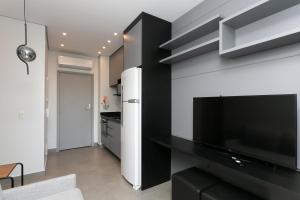 a living room with a large flat screen tv on a wall at VN Capote Valente 712 no coração de São Paulo in Sao Paulo