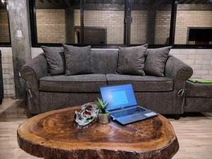 a laptop on a coffee table in a living room at Balai Diclum in Manolo Fortich