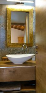 a bathroom sink with a large mirror on a counter at Villa Emma-Toscanaparadiso in Pomaia
