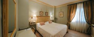 Ένα ή περισσότερα κρεβάτια σε δωμάτιο στο Hotel Bramante