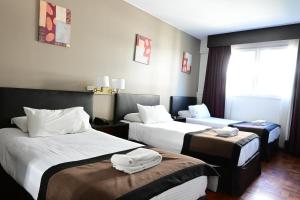 Cama ou camas em um quarto em Hotel Mendoza
