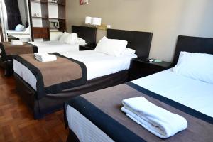 Cama ou camas em um quarto em Hotel Mendoza