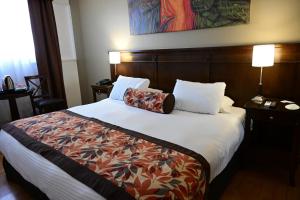 Cama ou camas em um quarto em Hotel Mendoza