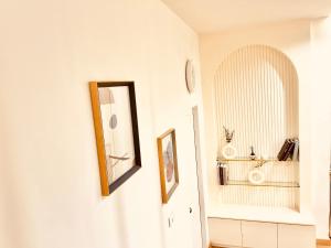 a hallway with a mirror and a white wall at Markai Banphai in Ban Phai