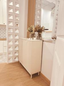 a kitchen with white cabinets and a walk in closet at Markai Banphai in Ban Phai +9 photos