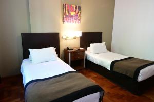 Cama ou camas em um quarto em Hotel Mendoza