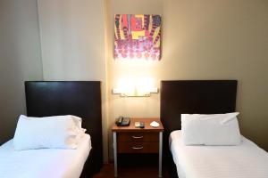 Cama ou camas em um quarto em Hotel Mendoza