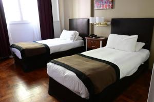 Cama ou camas em um quarto em Hotel Mendoza