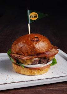 a sandwich on a plate with a flag on it at The Click Clack Hotel Bogotá in Bogotá