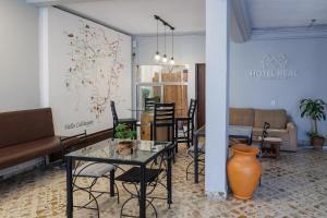 a living room with a table and chairs at Hotel REAL CAFAYATE in Cafayate