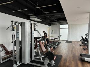 a group of people exercising in a gym at Kuching Cozy Comfort 02 - Kozi Square Studio in Kuching
