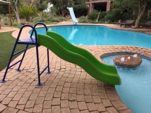 a slide in the middle of a swimming pool at Shelanti Game Reserve in Marken +34 photos