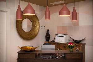 a room with a table with a mirror and some lights at Residenza Leone XIII in Rome
