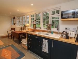 a kitchen with a sink and a counter top at Laundry Cottage in Bideford