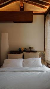 a bed with white sheets and pillows in a bedroom at Unwadang Private Luxury Hanok House in bukchon in Seoul