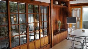 a dining room with glass doors and a table at Unwadang Private Luxury Hanok House in bukchon in Seoul