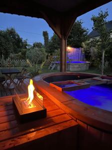 a statue sitting on a deck next to a swimming pool at Gîte cottage à 5 min de Dinan avec bain nordique "Côté Jardin" in Bobital