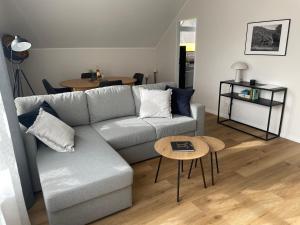 a living room with a couch and a table at Moderne Wohnung - renoviert 2024 in Solingen