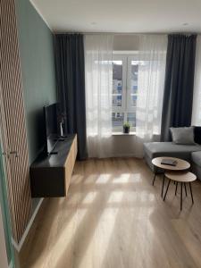 a living room with a couch and a table at Moderne Wohnung - renoviert 2024 in Solingen