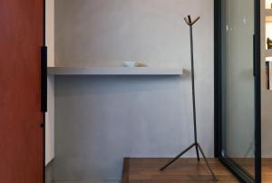 a white wall with a shelf and a pole at Lane in Niigata