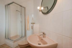a bathroom with a sink and a toilet and a mirror at Monteurzimmer Usedom in Usedom Town +18 photos